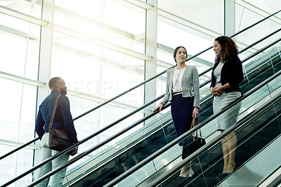 Buy stock photo Employees, escalator and morning in office building for business, new day or coworkers on lift. People, corporate team or stairs in company with meeting schedule, discussion or planning productivity