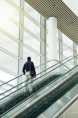 Buy stock photo Business lounge, airport and man on escalator for travel, commute and arrive in lobby for global trip. Building, professional and person on electric stairs for journey to convention or conference