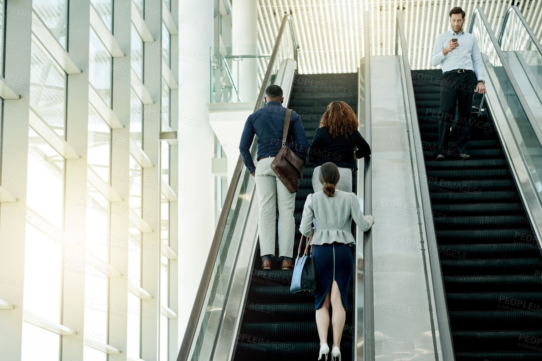 Buy stock photo Professional, people and travel on escalator at airport for business trip, meeting arrival or international expo. Employees, back and bags on moving staircase for corporate journey or work departure