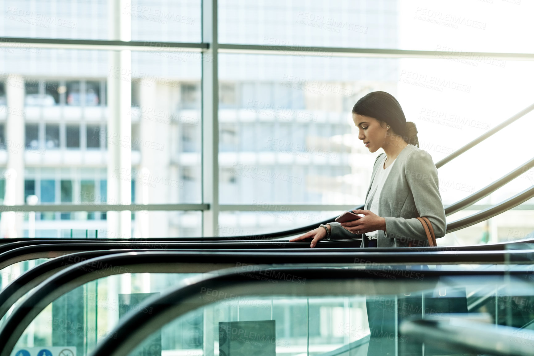 Buy stock photo Escalator, office and business woman in lobby for travel, commute and arrival to work in morning. Building, professional and person on electric stairs for convention, company event or conference