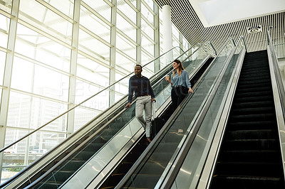 Buy stock photo Escalator, suitcase and talking with employee people in airport together for travel or trip. Collaboration, luggage and smile of business woman with man colleague in lobby for international flight