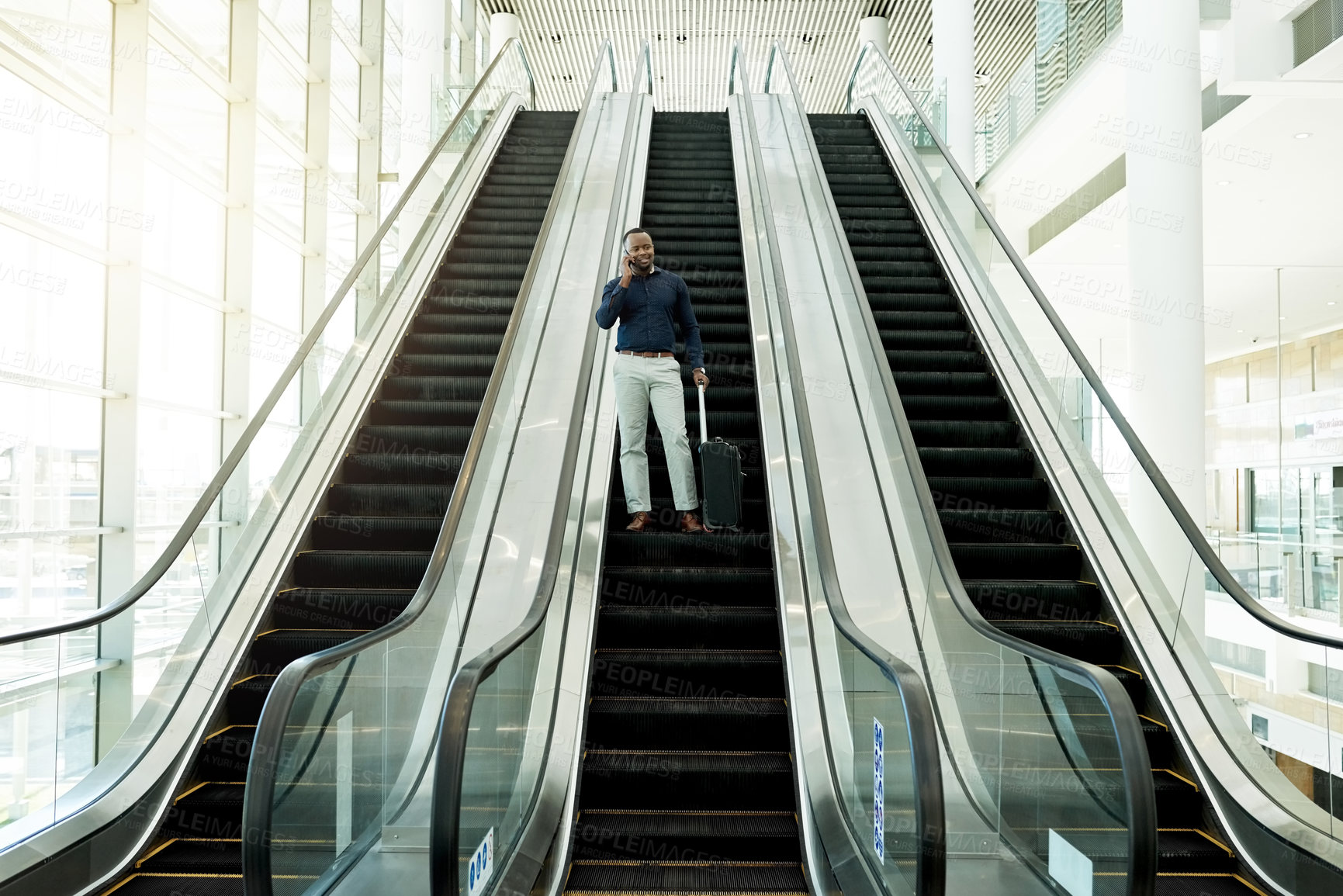 Buy stock photo Phone call, office and business black man on escalator for commute, travel and arrival in lobby. Transport, conference and African person on electric stairs with smartphone for contact and networking