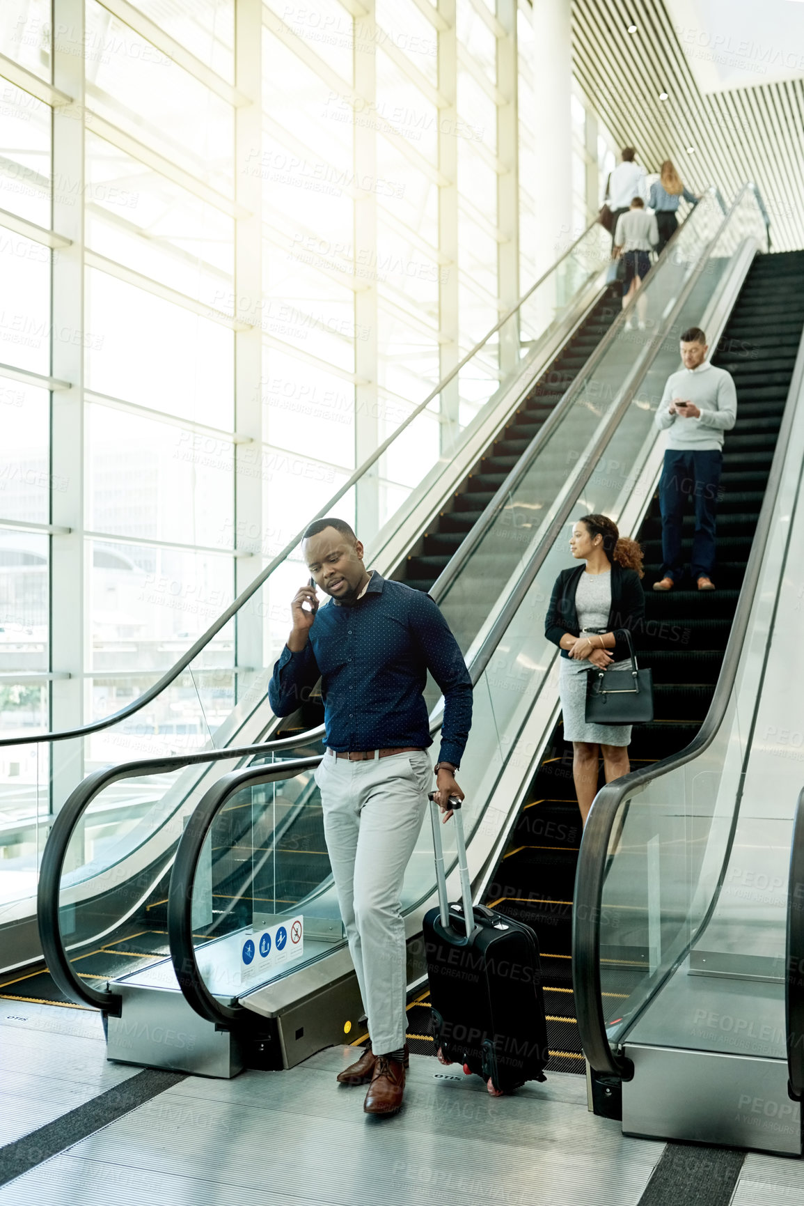 Buy stock photo Man, phone call and luggage at escalator for travel, business contact and booking accommodation. Journalist, suitcase and tech in airport for source lead, information update or planning trip for news