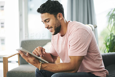 Buy stock photo Relax, tablet and man on sofa in living room with online sports chat for fan polls with match update. Happy, digital technology and male person reading tournament results on website blog in home.
