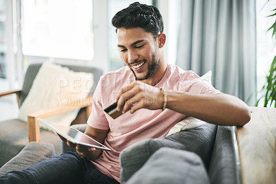 Buy stock photo Credit card, online shopping and man on sofa on tablet for internet discount, purchase and payment in home. Ecommerce, fintech and person on digital tech for website sale, subscription or banking app