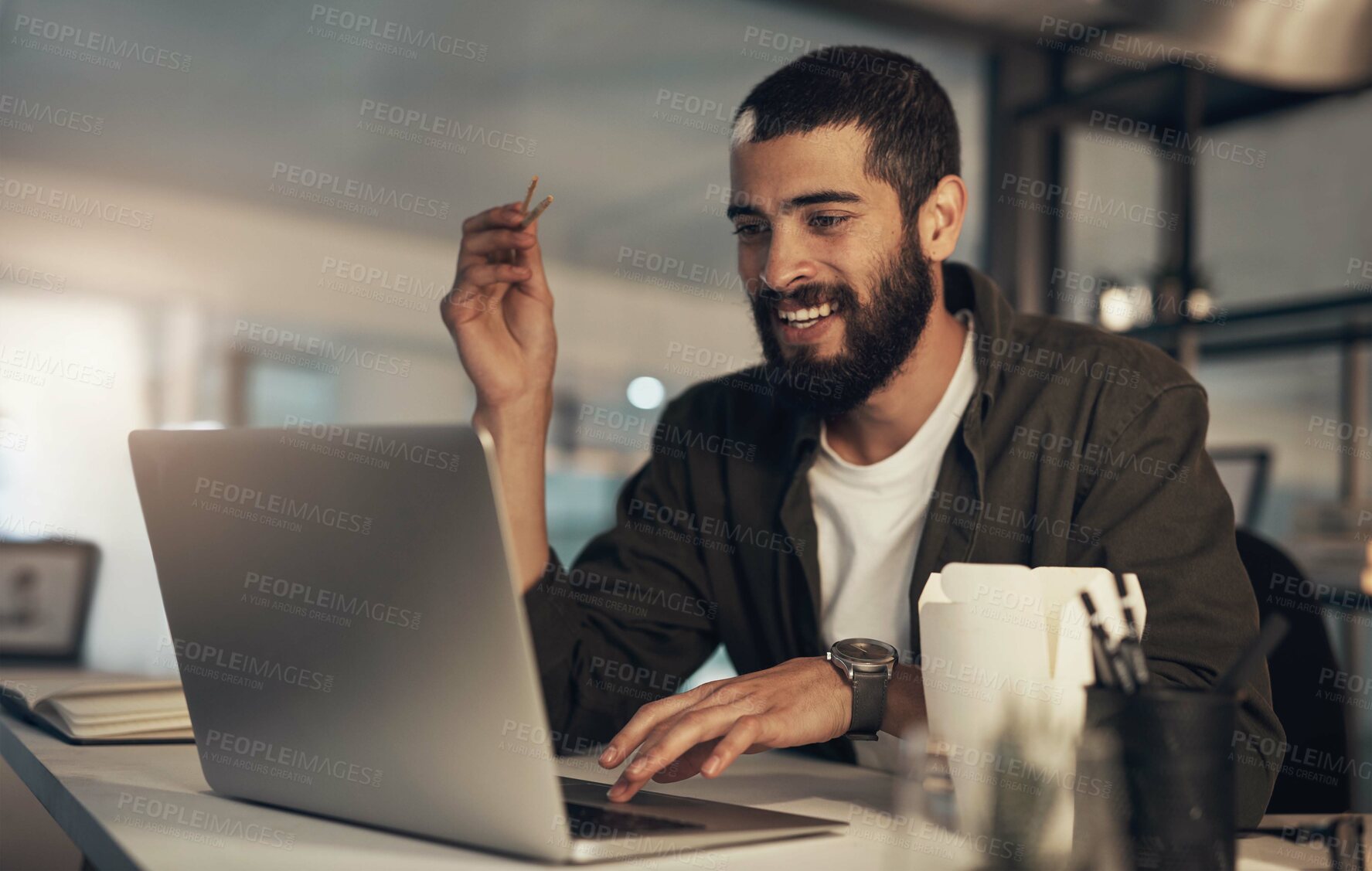 Buy stock photo Food delivery, laptop and night with business man in office for takeaway, deadline and dinner break. Smile, eating and research with person and meal order in creative agency for nutrition and hunger