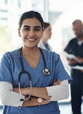 Buy stock photo Portrait, nurse and happy woman with arms crossed in hospital for healthcare career, wellness and proud. Face, smile and confident medical professional doctor, surgeon or expert employee coworking