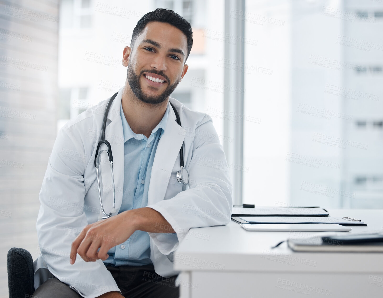 Buy stock photo Portrait, doctor and happy man in hospital for healthcare service, job or career in Saudi Arabia. Face, smile and medical professional employee, expert surgeon and worker in clinic office at desk