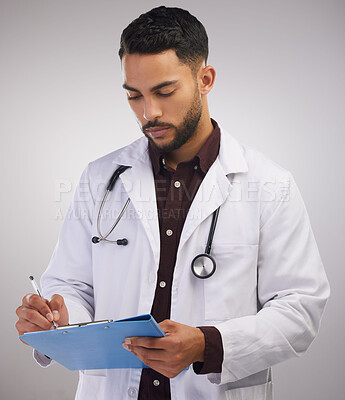 Buy stock photo Doctor, chart and writing notes in studio for healthcare, wellness or information isolated on white background. Checklist, serious and medical professional on document, report or research results