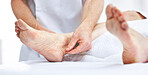 An unrecognizable woman getting needles inserted into her foot during an acupuncture session. Closeup of patient getting alternative therapy for medical treatment