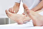 An unrecognizable woman getting needles inserted into her foot during an acupuncture session. Closeup of patient getting alternative therapy for medical treatment