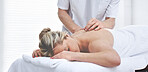 A young woman getting needles inserted into her back during an acupuncture session. A patient getting alternative therapy for medical treatment
