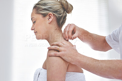 Buy stock photo A young woman getting needles inserted into her back during an acupuncture session. A patient getting alternative therapy for medical treatment