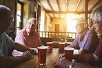 Group of senior men sitting together in a bar, bonding, senior friends enjoying a day in a pub