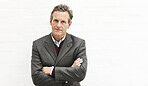 Portrait of a businessman, isolated on a white background. A mature male executive looking confident about business in an office or studio