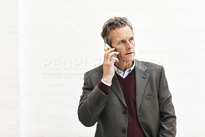 Buy stock photo A businessman using a phone to make a call, isolated on a white background. A mature male executive talking on a smartphone for business in an office or studio