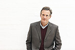 Portrait of a businessman, isolated on a white background. A mature male executive looking confident about business in an office or studio
