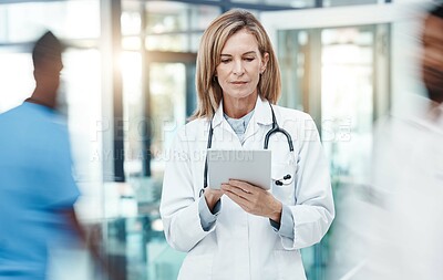 Buy stock photo Woman doctor, digital tablet planning and healthcare working in busy hospital on medical research, online test results and technology. Mature, focus and expert telehealth surgeon connect clinic app