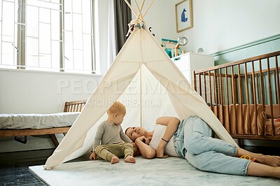 Buy stock photo Mother, baby and tent in family home for play, bonding and development on floor with love, care and relax. Woman, mama and young infant kid in bedroom with camping game, teepee and lying in house
