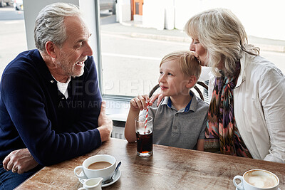Buy stock photo Senior man, woman and child in cafe, drink and soda with funny talk, vacation and relax with kiss. Grandparents, restaurant and boy with glass, tea cup and matcha with smile, laugh and conversation