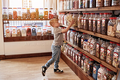 Buy stock photo Boy child, jar and candy in shop for gift, present and choice with thinking, dessert and sugar treat. Customer, kid and retail store with container for sweets sale, decision and shopping for food
