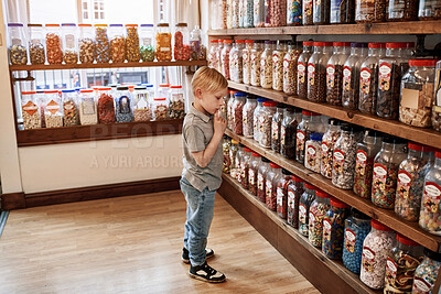 Buy stock photo Kid, choice and candy in shop by shelf, present and jar with thinking, dessert and sugar snack. Customer, boy child and retail store by container for sweets sale, decision or shopping for discount