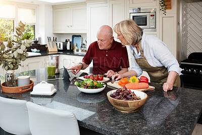 Buy stock photo Home, cooking and senior couple with a tablet, internet and digital app with instructions, vegetables or online recipe. Kitchen, elderly man or old woman with technology, conversation or healthy food