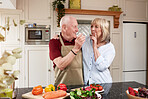 Love, cooking and senior couple in a kitchen with care, fun and bonding at home. Health, food and hungry old people with vegetables for meal prep, brunch or detox, weight loss or vegan lunch salad 