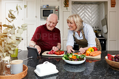 Buy stock photo Home, cooking and senior couple with a tablet, smile and digital app with instructions, vegetables and internet. Kitchen, elderly man and old woman with technology, online recipe and healthy food