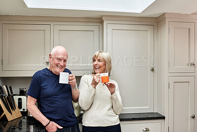 Buy stock photo Coffee, laughing and senior couple in kitchen at home together in the morning for conversation, love and healthy connection. Tea, funny and elderly man and woman enjoying drink in mug in retirement.