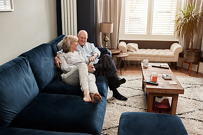 Buy stock photo Tea, relax and retirement with a senior couple on a sofa in the living room of their home for conversation. Love, smile or wellness with a happy elderly man and woman talking in their apartment