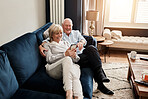 Phone, relax and retirement with a senior couple on a sofa in the living room of their home for conversation. Mobile, smile or wellness with a happy elderly man and woman talking in their apartment