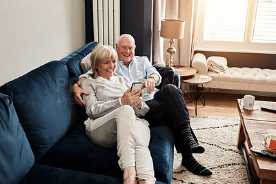 Buy stock photo Phone, relax and retirement with a senior couple on a sofa in the living room of their home for conversation. Mobile, smile or wellness with a happy elderly man and woman talking in their apartment