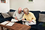 Senior couple reading documents in home for planning budget, financial assets and legal contract for insurance policy. Man, woman and paperwork of investment information, bills and retirement savings