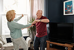 Happy senior couple, dancing and home in living room with celebration, love or bonding with memory. Elderly woman, old man and dancer in house for steps, performance or party in lounge for retirement