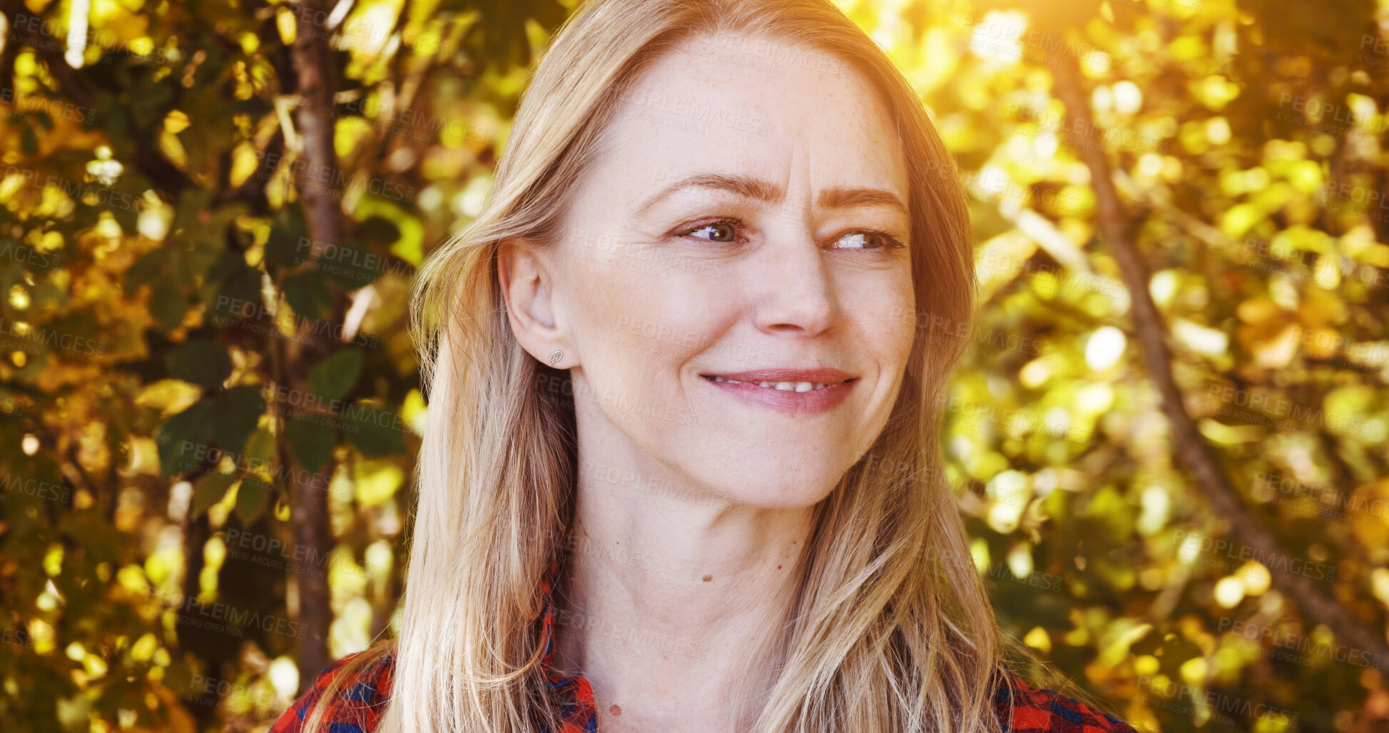 Buy stock photo Nature, happy and woman by trees with sunshine for wellness, fresh air and relax outdoors. Countryside, smile and person in forest, woods and morning for calm, joy and freedom in natural environment