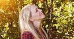 Trees, happy and face of woman in morning for wellness, fresh air and relax outdoors. Countryside, smile and person in forest, woods and nature for joy, cheerful and freedom in natural environment