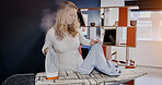 Woman, iron and steam for garment in home for cleaning, domestic work or chore with ironing on board. Female person, wife or housekeeping with electricity for laundry, shirt or pyjamas in living room