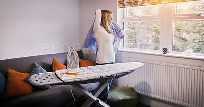 Buy stock photo Iron, board and woman with shirt in morning, press cleaning or dressing for work as a cleaner in apartment. Ironing, laundry and person in living room with uniform, blouse or clean clothes in home