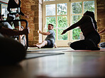 Coaching, instructor or people stretching in yoga class for support or body flexibility in studio together. Teaching, start or calm group learning in pilates for chakra energy, balance or wellness