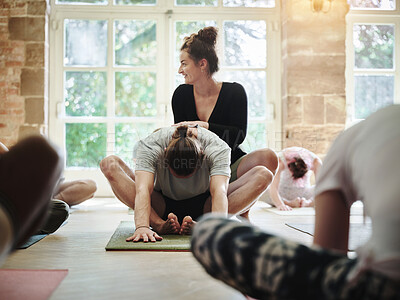 Buy stock photo Teaching, learning yoga and woman with group of people on floor in fitness class, health or mindfulness together. Help, support and stretching, coaching men and women in exercise, wellness or gym