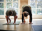 Man, yoga and coach in class for stretching, exercise or workout together in pose on mat at gym or dojo. Woman, mentor or personal trainer helping yogi for balance, support or wellness in pilates