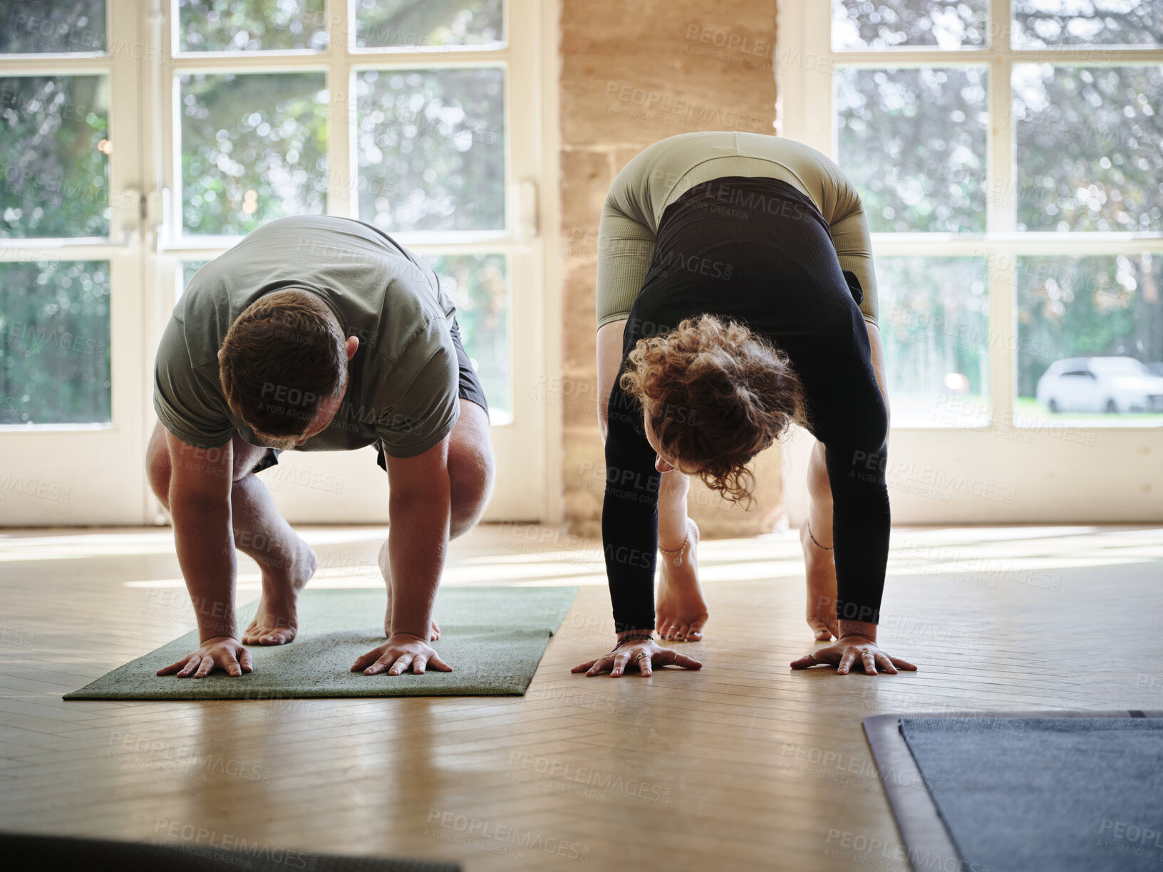 Buy stock photo Man, yoga and coach in class for stretching, exercise or workout together in pose on mat at gym or dojo. Woman, mentor or personal trainer helping yogi for balance, support or wellness in pilates