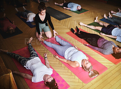 Buy stock photo Yoga, personal trainer and people on floor for fitness, exercise and wellness in studio. Health club, pilates class and instructor with group of men and women for workout, balance and corpse pose