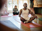 Zen, yoga or man in class for meditation, breathing or body flexibility in a group or studio for peace. Pilates club, energy or healthy person on mat in calm pose for mindfulness or wellness together