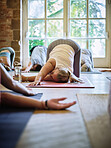 Woman, yoga class or stretching arm for body flexibility or healing in zen studio with energy. Community, relax or group of calm people in pilates with mindfulness, support or wellness for chakra