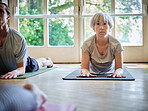 Senior woman, yoga or class for body balance, breathing or healing in zen studio for flexibility. Community, relax or group of calm people in pilates with mindfulness, support or wellness together 