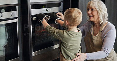 Buy stock photo Oven, cooking and mature woman with child in kitchen together with love and bonding in retirement. Baking, skills and development of kid helping or learning with grandmother  in home with food
