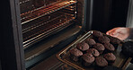 Muffins, cooking and hands with tray from oven, kitchen or morning in bakery with process or production. Baking, dessert or person with cupcakes for a delicious snack, pastry or prepare food in home