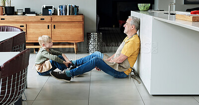 Buy stock photo Bonding, conversation and grandfather with child in the kitchen sitting on the floor together at home. Sweet, communication and senior man talking to young boy kid from Australia at modern house.